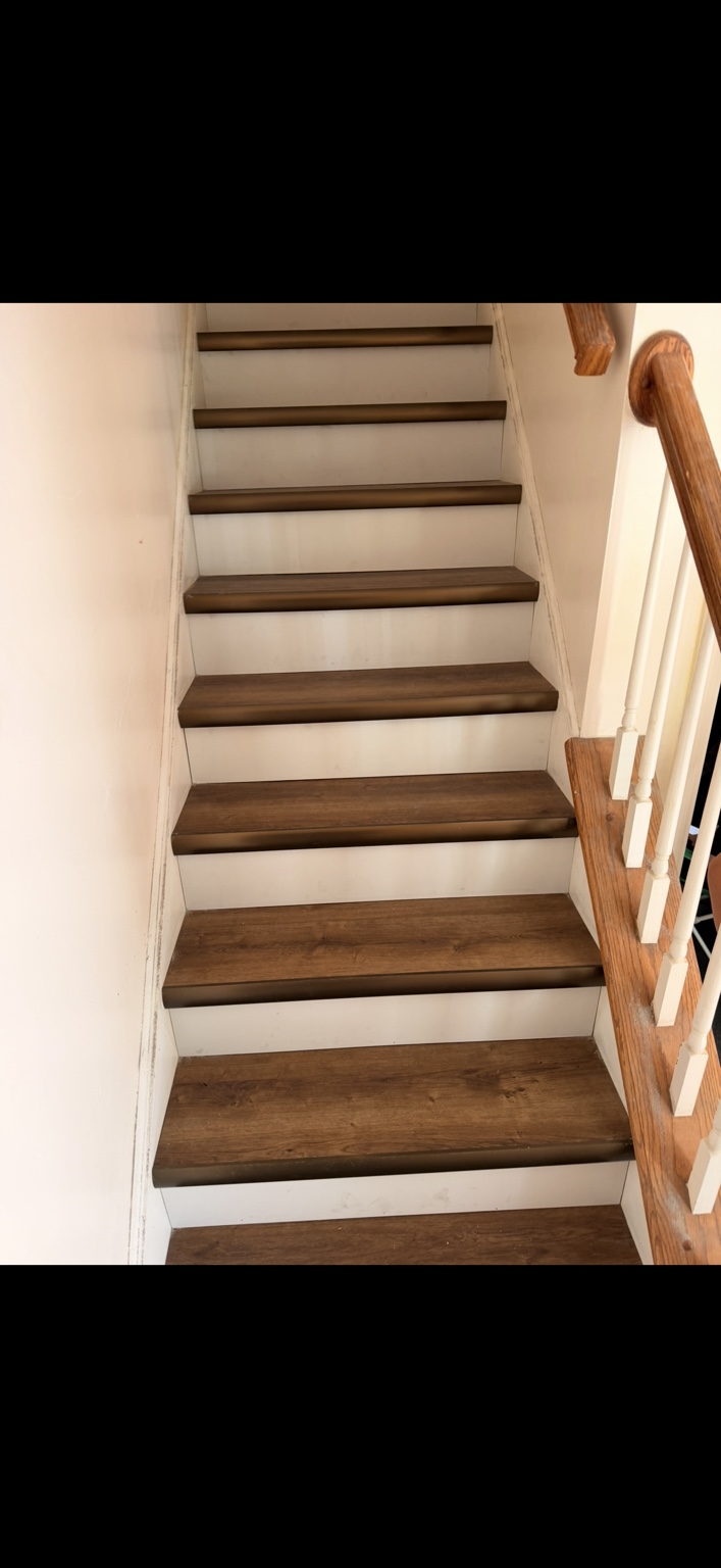 Staircase with finished wood-look treads and white risers
